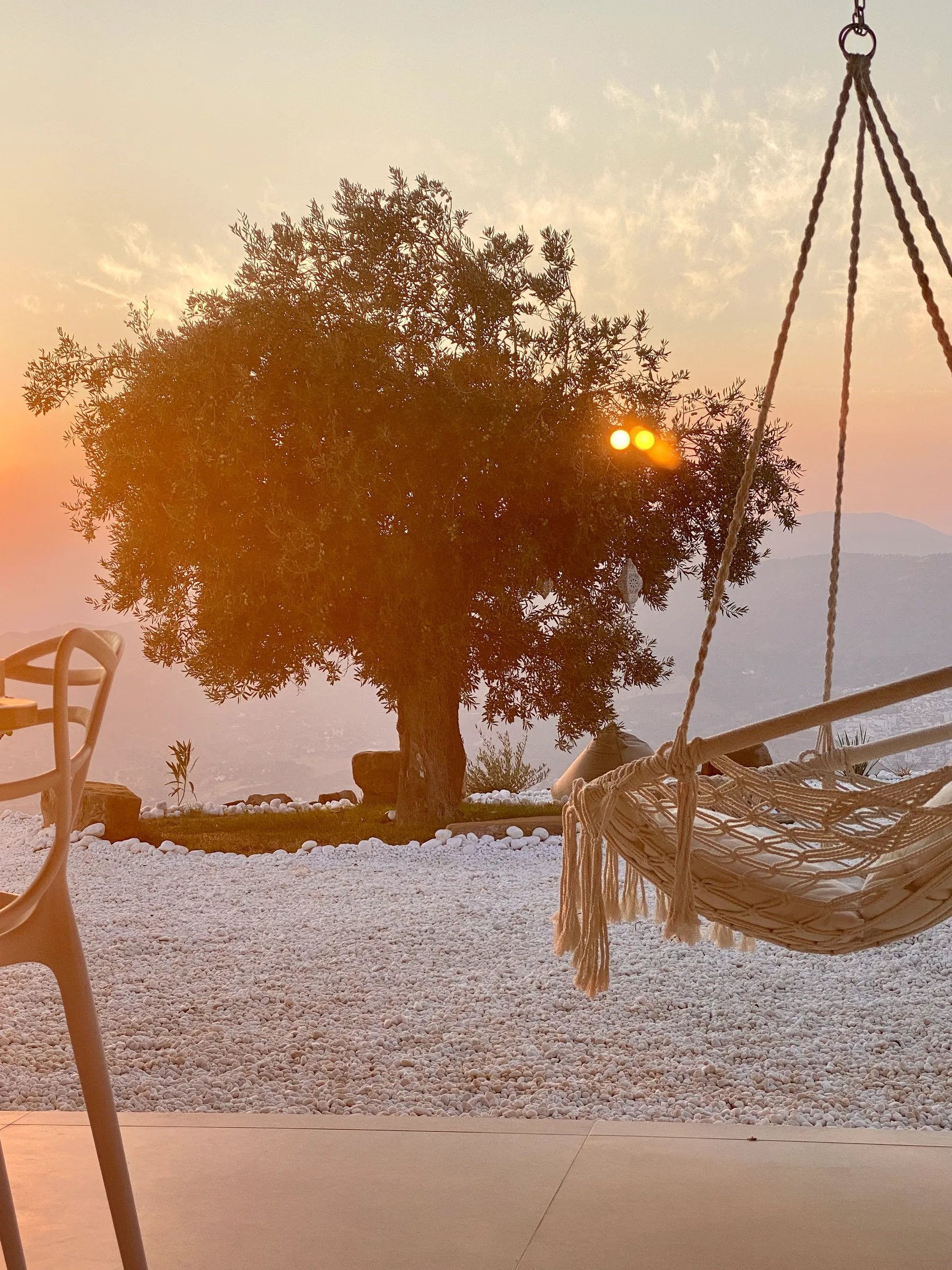 Hanging chair at sunset overlooking the valley