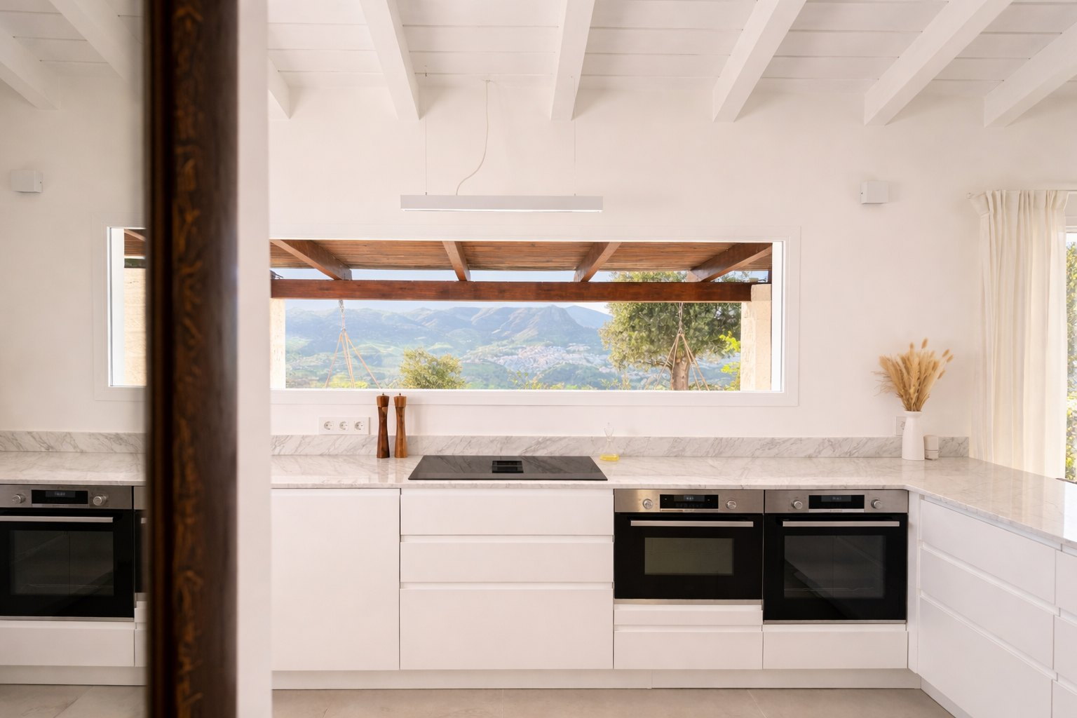 Casa Lux kitchen with scenic mountain views over Álora