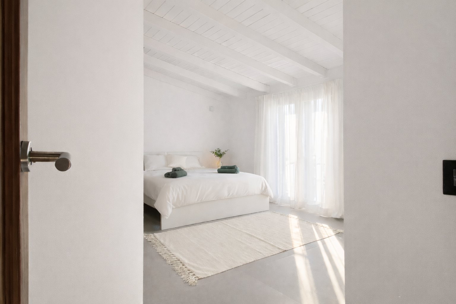 Casa Lux master bedroom with king-size bed, white bedding and soft natural light