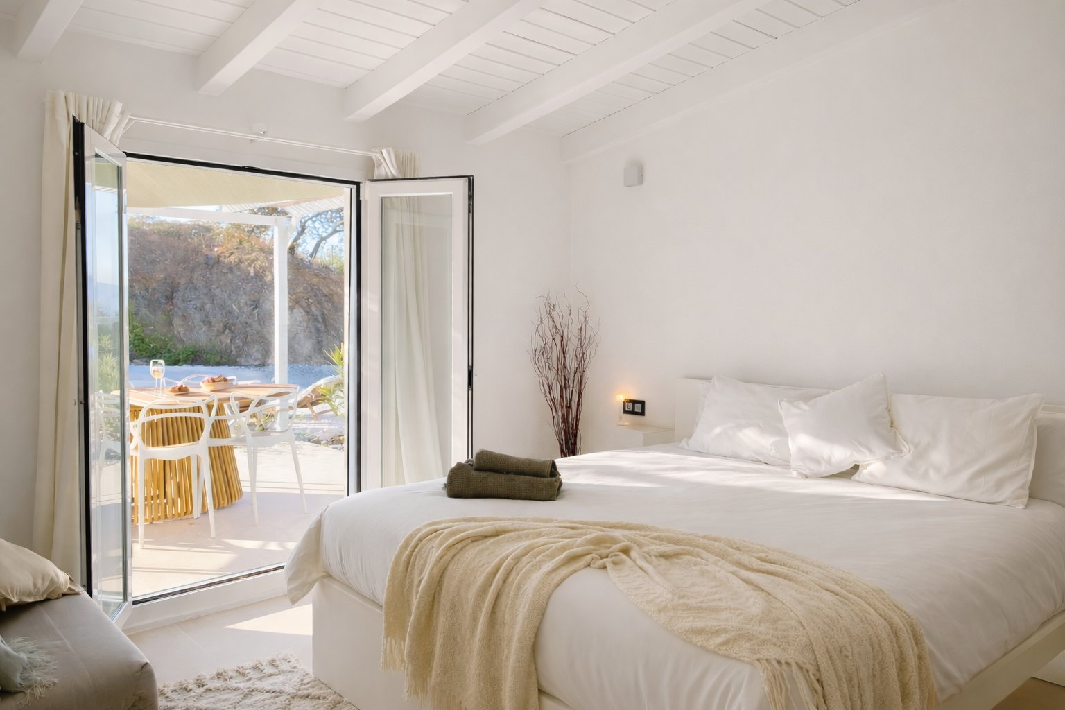 Casa Lux bedroom opening to a private patio view
